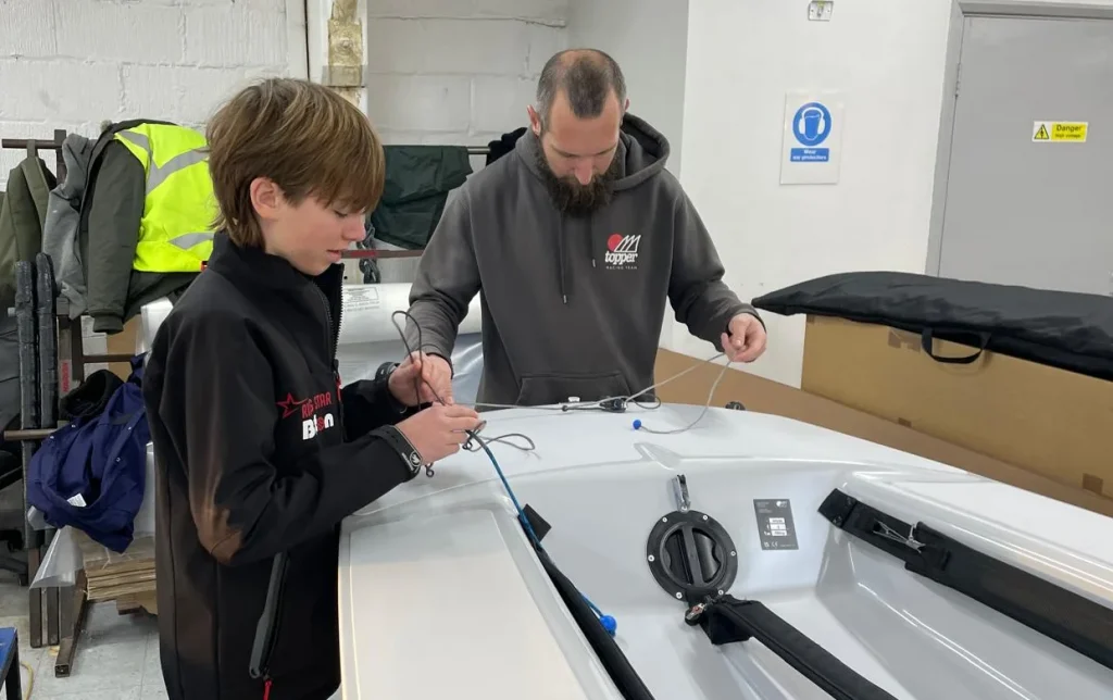 Ralph working with the Topper team to get his boat ready for the water