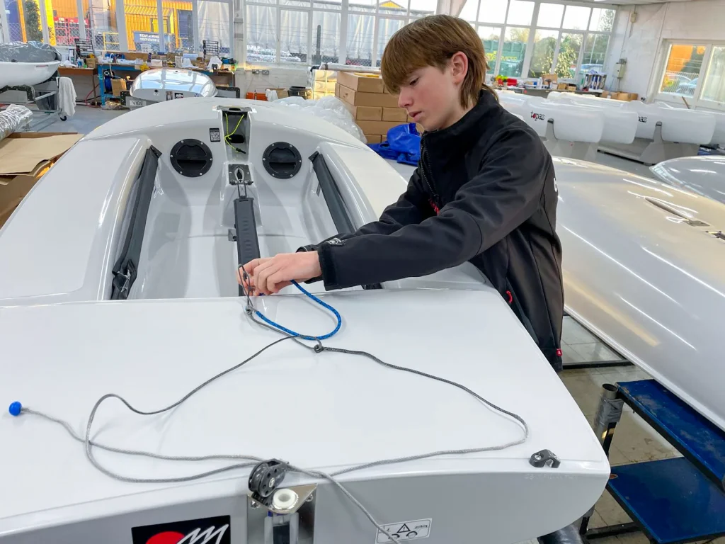 Barton Rising Star Ralph at the Topper factory rigging his new hull 